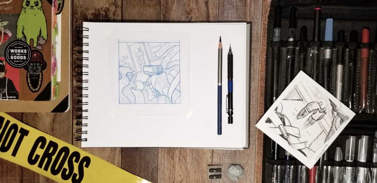 A work desk showing a work in progress sketch on a sketch pad, illustration pens and pencils, and a real yellow police crime scene tape in the corner.