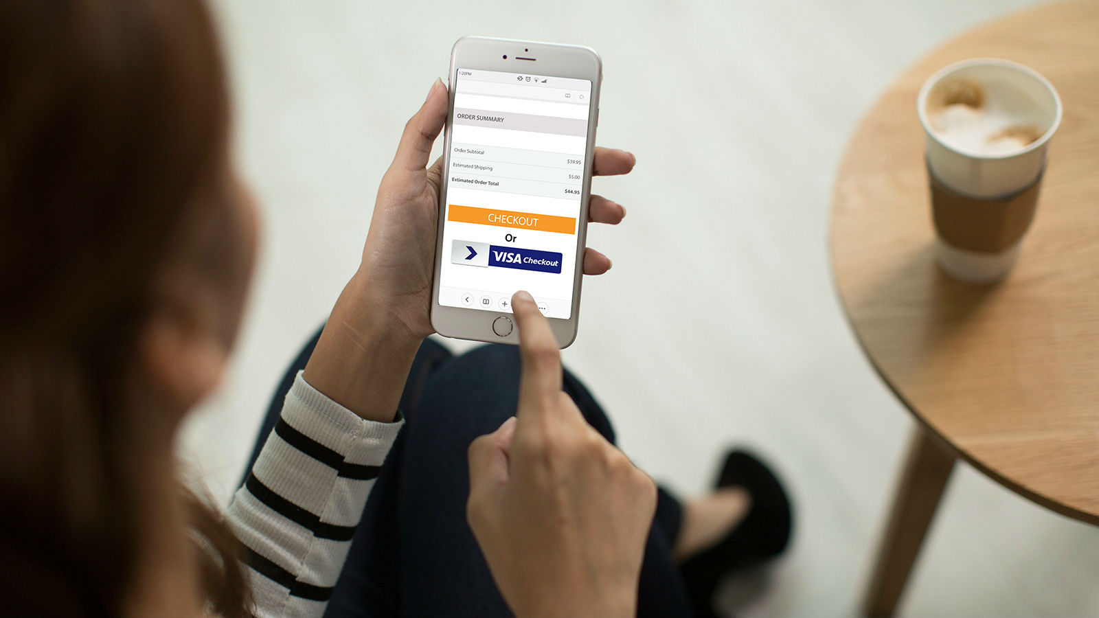  A person is using the Visa B2B Connect platform on their phone to make a payment.