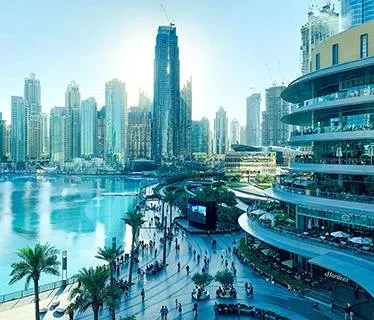Dubai skyline with pool and palm trees in foreground
