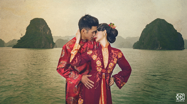 Bride and groom in traditional Vietnamese Áo dài, posing with Ha Long Bay in the background.