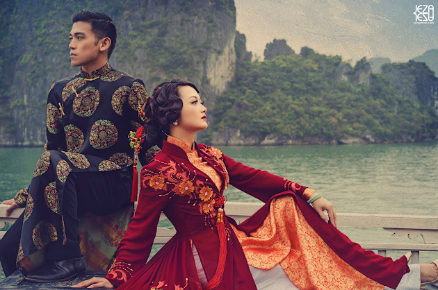 Bride and Groom in Vietnamese Áo dài, sitting on junk boat in Ha Long Bay, Vietnam