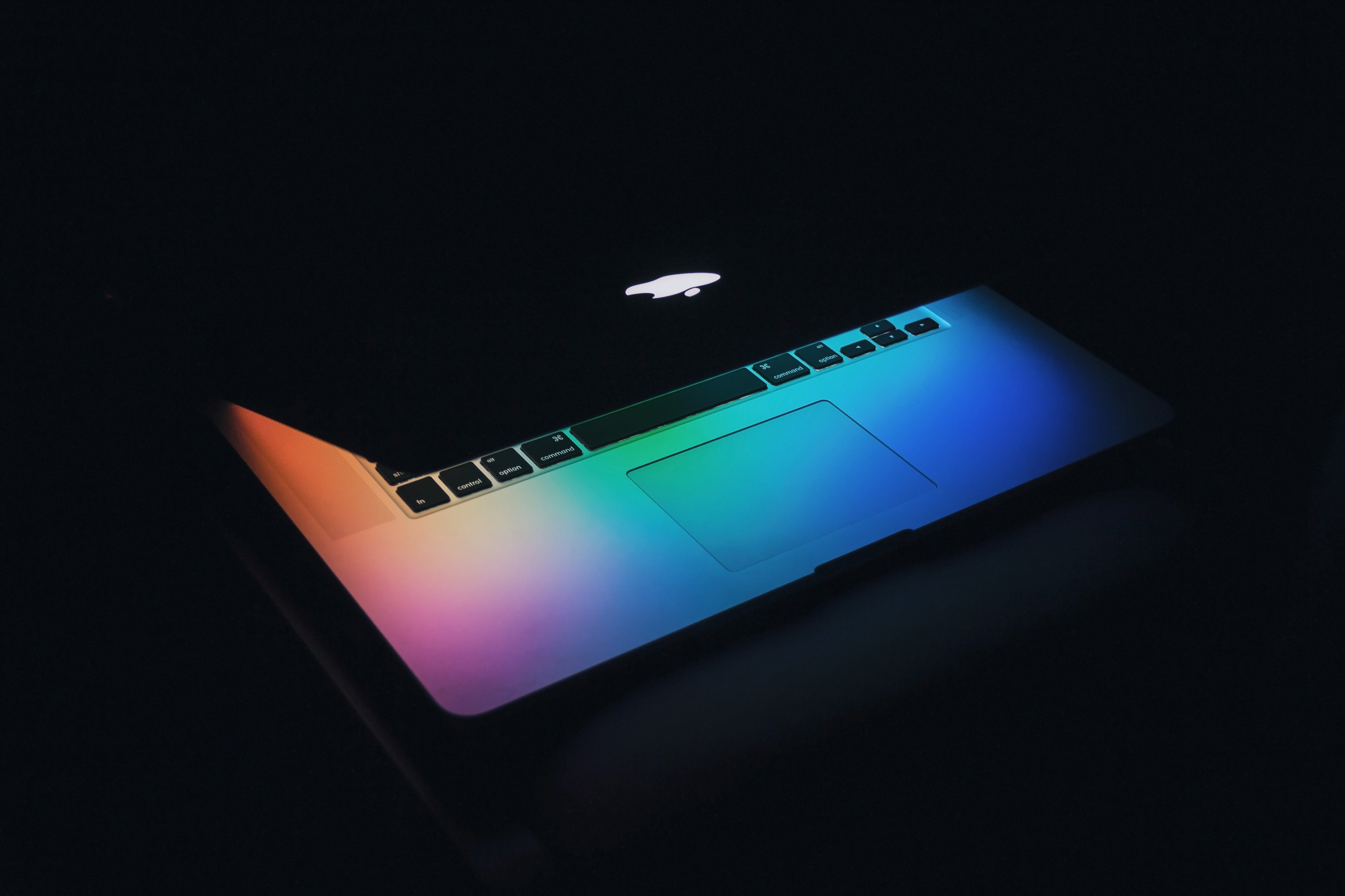 Macbook partially open in the dark