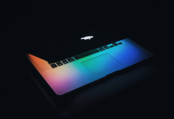 Macbook partially open in the dark