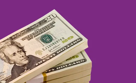 Stacks of $20's on purple background