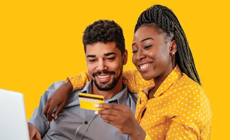 Couple looking at yellow card on yellow background