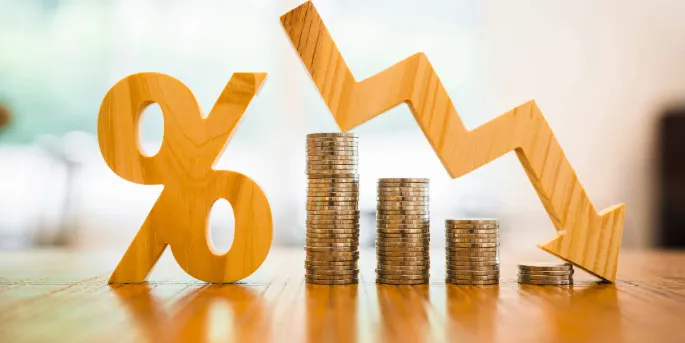 Orange percentage symbol, descending stacks of coins, and downward arrow illustrating declining interest rates or financial decrease.