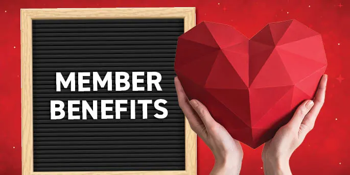 Hands holding a large red geometric heart next to a letterboard sign reading MEMBER BENEFITS on a red background