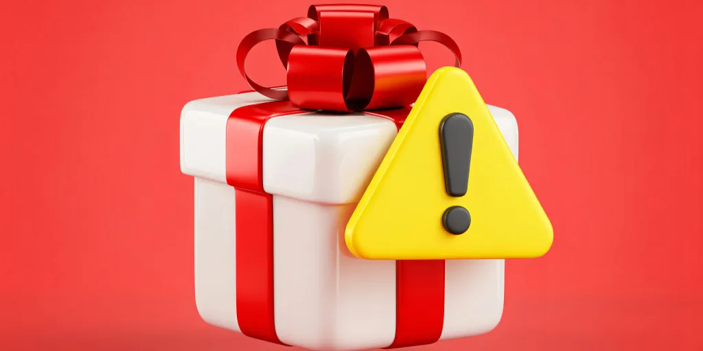 White gift box with red ribbon and bow next to yellow warning triangle with exclamation mark on red background.