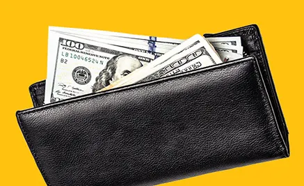 Black leather wallet with one hundred dollar bills protruding from the top against a bright yellow background.