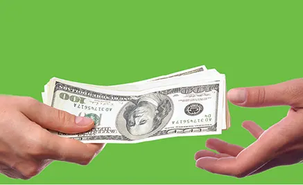 Two hands exchanging one hundred dollar bills against a bright green background