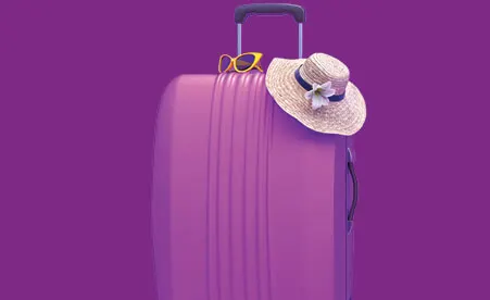 Purple suitcase with sunhat on purple background