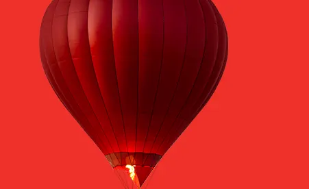 Hot air balloon on red background