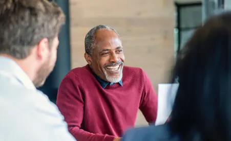 Smiling Man at deal desk
