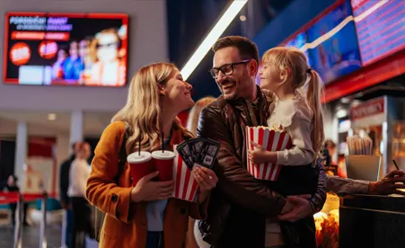 Family with Popcorn at Movie theatre