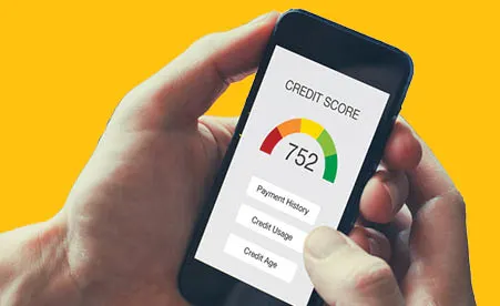 Hand holding device with credit report on yellow background