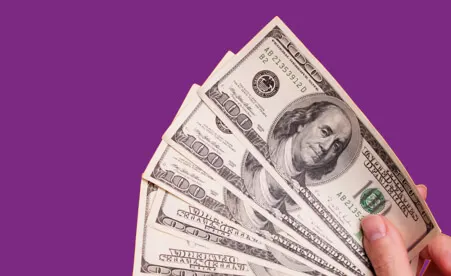 Spread cash on purple background