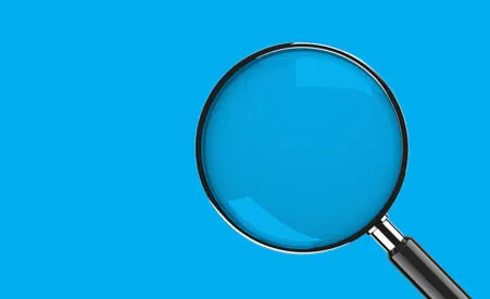 Magnifying glass on blue background