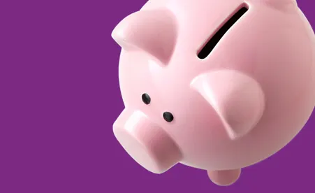 Piggy bank on purple background