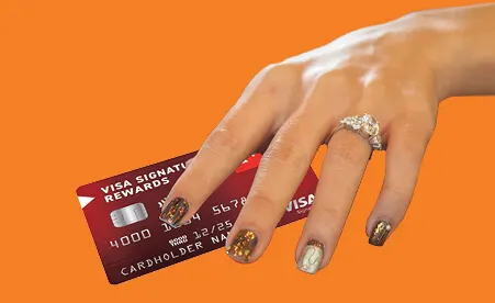 Hand with Visa Signature Card on orange background