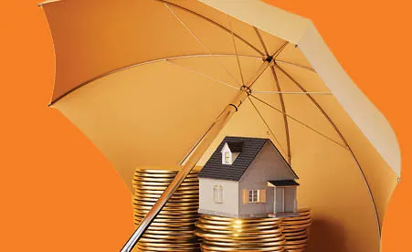 Umbrella over coins and miniature house on orange background