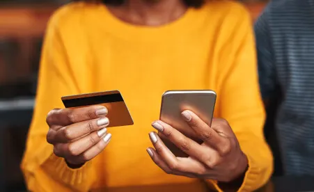Women using her phone with credit card