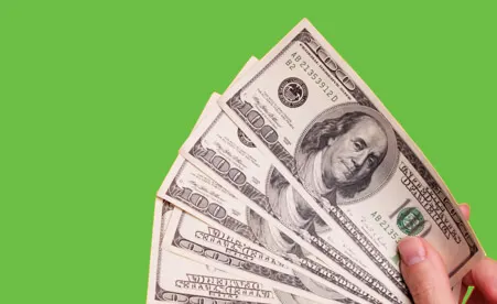 Spread of cash on green background