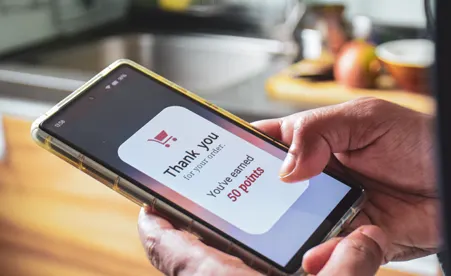hands using device with Thank You Points message