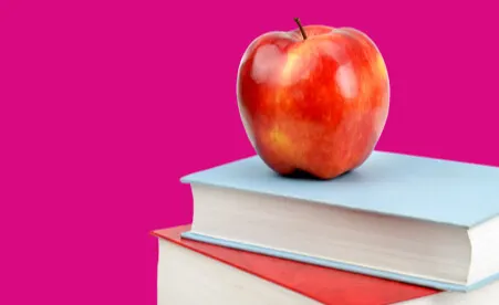 Books & Apple on pink background