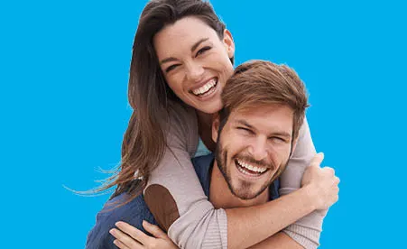 Couple piggy back on blue background
