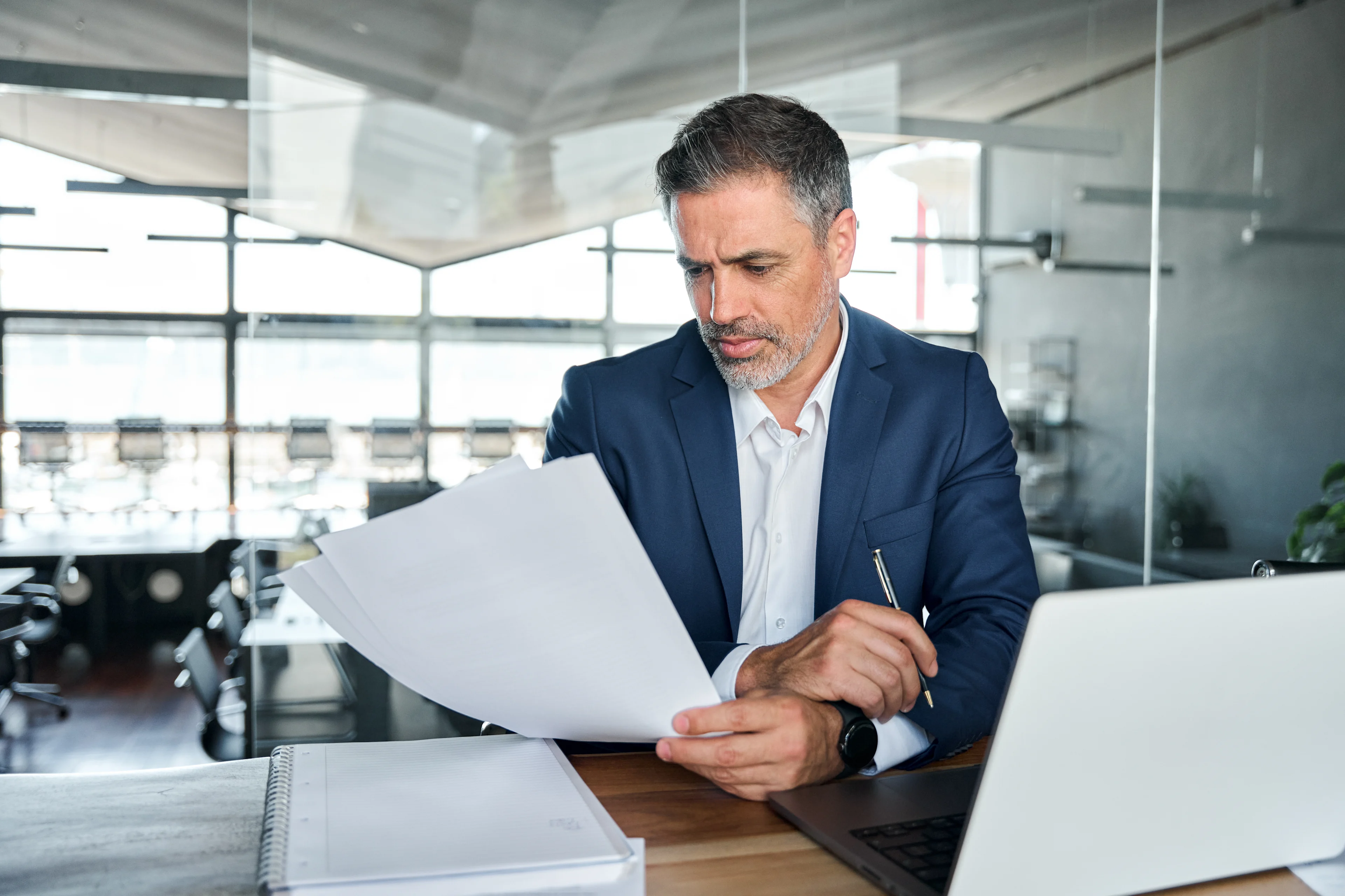 Man in office looking at paper