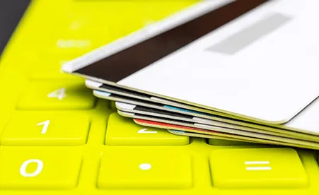 Yellow Calculator with Cards stacked on top