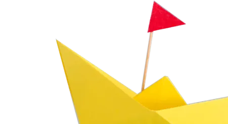 yellow Paper machet boat with red flag