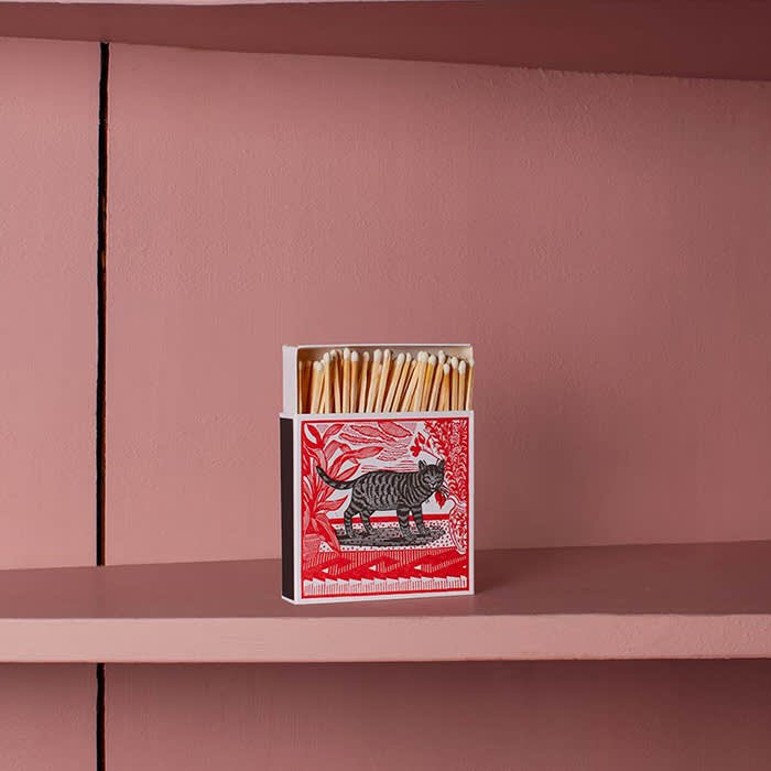 red matchbox with cat drawing on it
