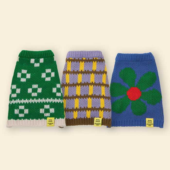 Little Beast x Memorial Day sweaters: one in floral green, one checkered, and one blue with green flower with red center