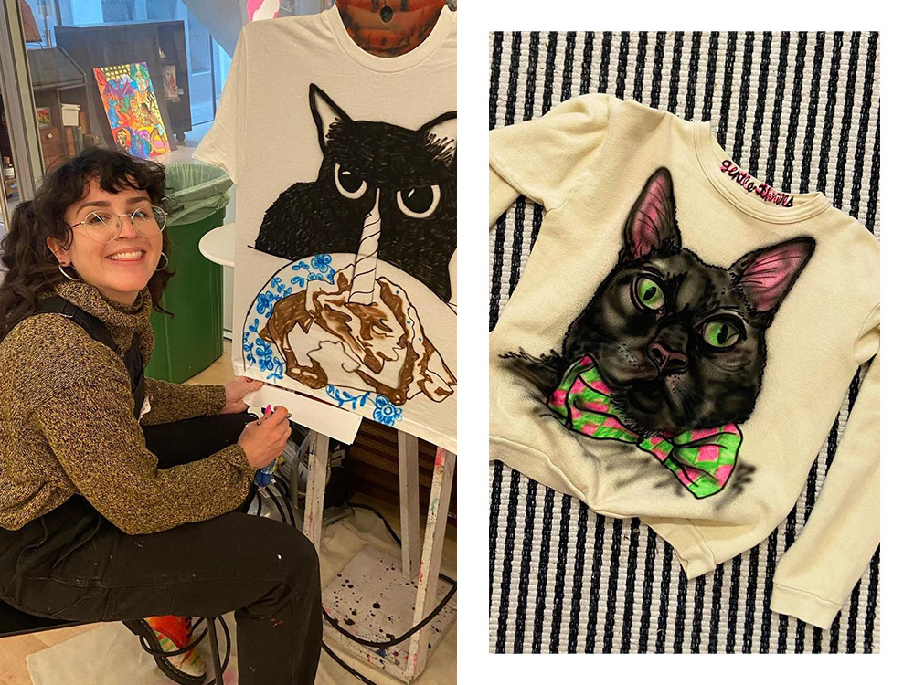 Isa of Gentle Thrills airbrushing a cat; an airbrushed sweater with a black cat on it 