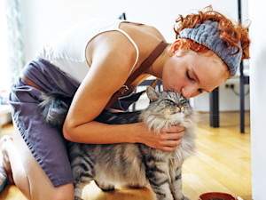 woman kissing a cat