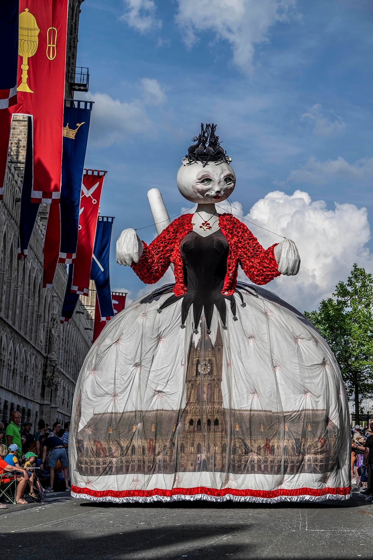 a picture of a giant cat in a dress in a parade
