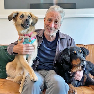 Jon Stewart and two dogs bringing awareness to dog adoption event.