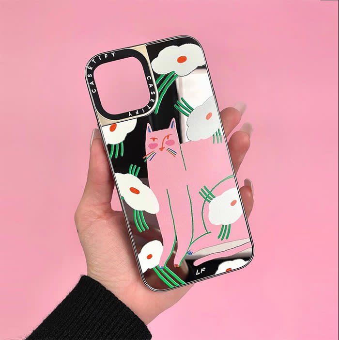 phone case being held in front of pink background