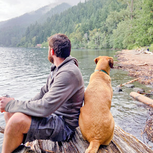 Man at a national park with his dog.