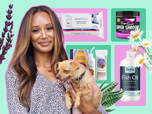 Dr. Lindsey Wendt holds a dog in front of a collection of allergy products.
