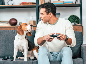 Man on the couch with his dog.