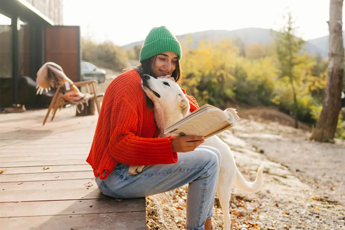 Dog with a person outside in autumn