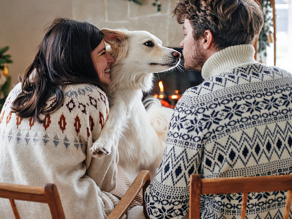 Couple celebrating the holidays with the dog.