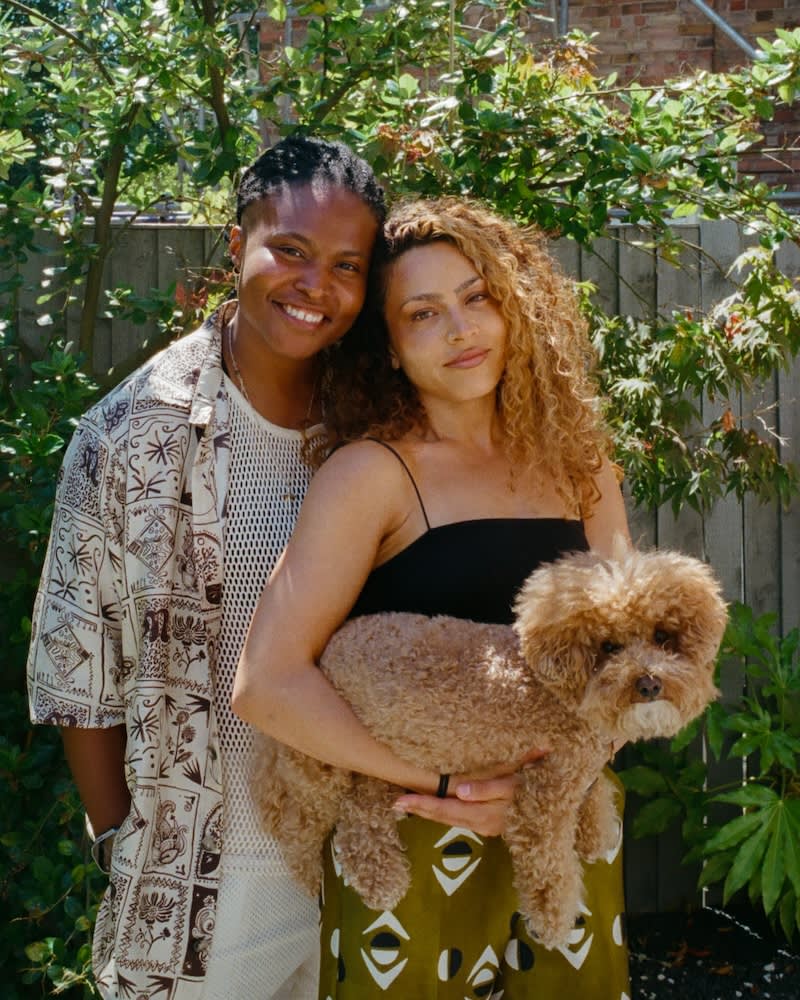 two women holding their dog