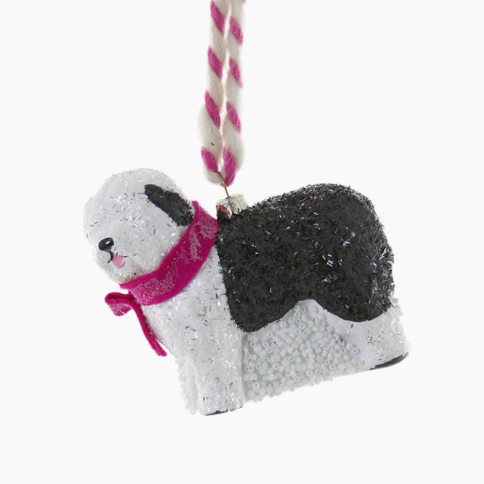 white and black sheep dog ornament with a pink collar