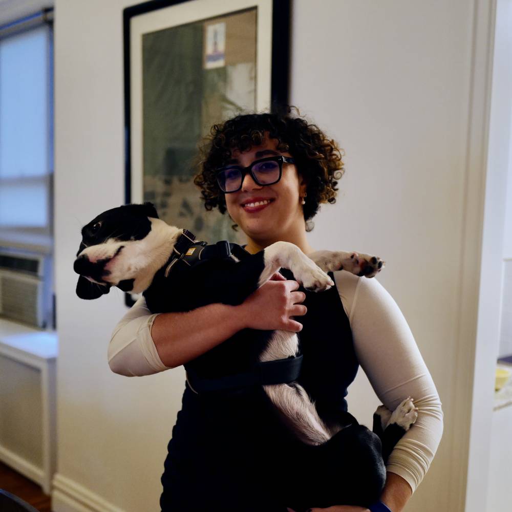 Esther Zuckerman poses with her dog