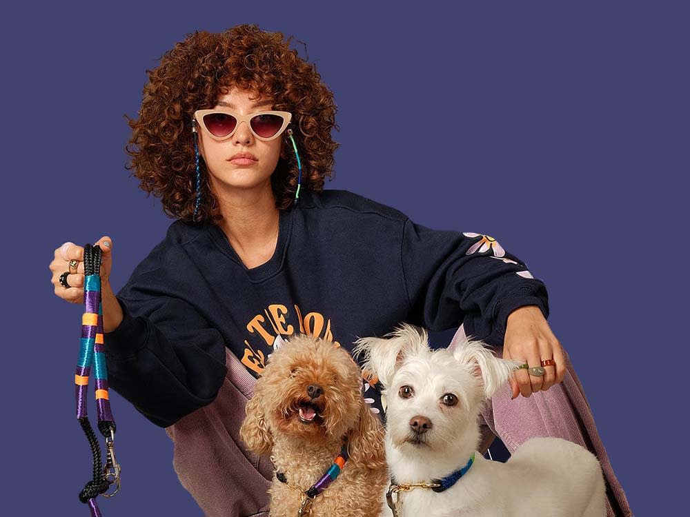 Color your life with unique handmade collars and leashes by Happy-Nes! Picture of curly haired woman and her two dogs on Happy-Nes leashes. 