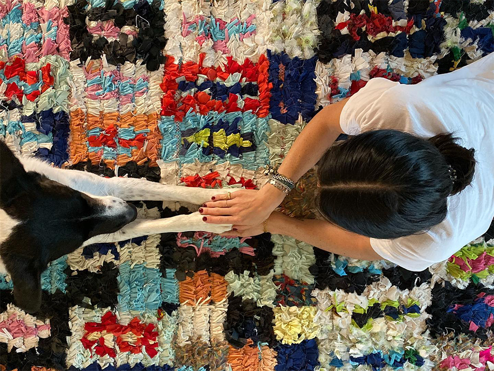 Calley Benoit Belli and her dog holding hands