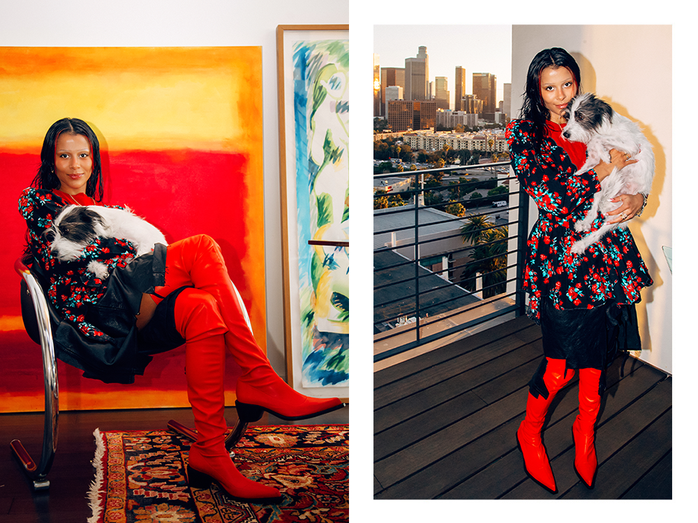 Sami Miró holding her small white rescue dog in front of a large painting; Sami Miró holding her small white rescue dog on a balcony